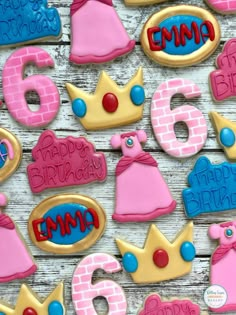 decorated cookies are arranged in the shape of princess's crowns and numbers on a table