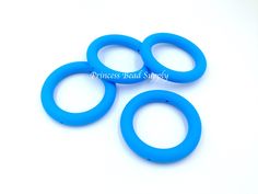 three blue rubber o - rings on a white background with the words princess read simply