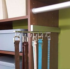 an iphone screenshot of a shelf with hanging belts and ties on it