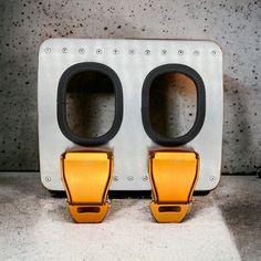 two yellow and black speakers sitting on top of a counter