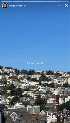 an image of a city from the top of a hill with buildings and trees in the foreground