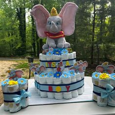 a cake made to look like an elephant with diapers and flowers on the bottom