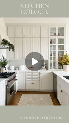 a kitchen with white cabinets and an area rug in front of the stove top oven