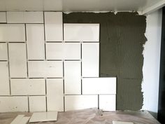 the walls are being painted and ready to be installed in this room with white tiles