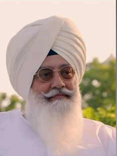 an old man with a white turban and glasses