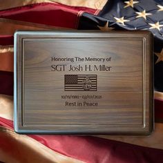 a plaque on top of an american flag with the words honoring the memory of st joseph h miller