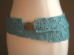 a crocheted belt is shown on a mannequin's torso,