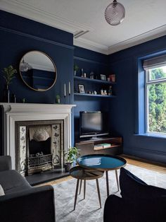 a living room with blue walls and a fireplace