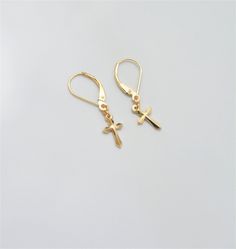 "Solid 14K Gold dangle earrings with cross charm - unisex earrings, mens earrings, womens earrings. These are simple and clean earrings featuring 13 mm cross charm. Cross charm has a beautiful cut creating \"3D\" effect and adding interest to the simple minimalist style of the earrings. These dangle earrings have a smooth reflective finish and secure lever back closure. They are lightweight, very comfortable to wear, and have a trendy modern look. Extra links at the top of the cross charms allow Nickel-free Gold Cross Earrings, Gold Nickel-free Cross Earrings, Minimalist Cross Pendant Earrings, Gold Cross Pendant Earrings For Gift, Gold Cross Pendant Earrings As Gift, Yellow Gold Cross Earrings For Pierced Ears, Elegant Cross Earrings For Everyday, 14k Gold Cross Earrings, Minimalist Gold Cross Earrings