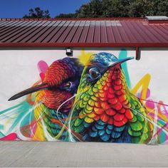 a colorful bird painted on the side of a building