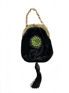 "a beautiful antique 1920s Art Deco celluloid silk velvet beaded purse  the  celluloid frame has a beautiful soft green marbled pattern  the exterior of the purse is made of black silk velvet and decorated with a beautiful round embellishment consisting or green jade glass beads, clear rhinestones and red glass bead in the center. on the bottom it has a large black tassel witch slide opener and celluloid link chain handle  the black fabric purse is securely hand stitched to the frame the purse i 20s Art, Velvet Purse, Textile Bag, Fabric Purses, 1920s Art, Beaded Bag, 1920s Art Deco, Beaded Purses, Rhinestone Bead