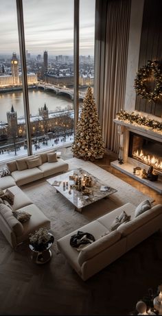 a living room filled with furniture and a christmas tree in front of a large window