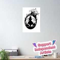 a desk with a computer and some stickers on the wall above it that says support independent artists