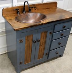 a bathroom sink sitting on top of a wooden counter next to a white wall and door