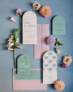 the wedding stationery was done in pastel colors and with flowers on each side