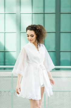 a woman in white dress holding a bouquet with text that reads, your bridal robe made from mom's wedding dress