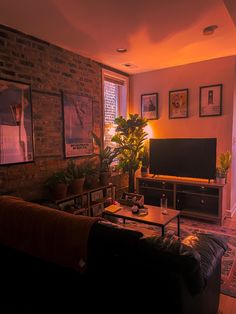 a living room filled with furniture and a flat screen tv sitting on top of a wooden table