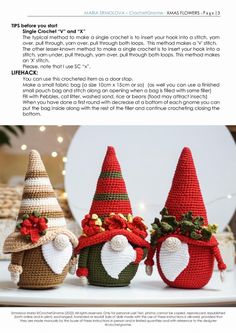 three crocheted christmas gnomes sitting next to each other on top of a table