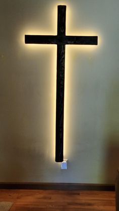 a cross is lit up on the wall