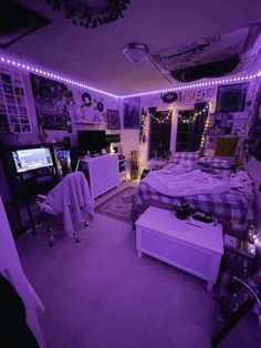 a bedroom with lights on the ceiling and a bed in the middle, television set to the side