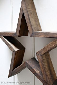 a wooden star hanging from the side of a door with two open sides on it