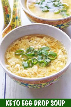 two bowls of egg drop soup on a table