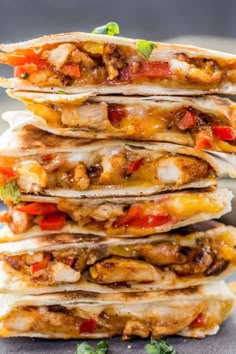 a stack of quesadillas stacked on top of each other with toppings