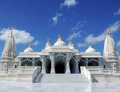 a large white building with many spires on it's sides and steps leading up to the entrance