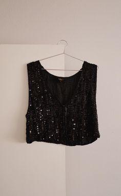 Late 70's - early 80's black silk beaded vest by Spell Bound. Such a stunning piece! Wear as a vest or as a top. Front neckline is a v-neck. Has eye hook closures on the front. Excellent vintage condition - all beading is in tact. Labeled a size medium. Made in India. Measurements Shoulder - Shoulder: 15.5" Bust: 19" Length: 19" Fitted Glamorous Evening Vest, Bohemian Fitted Vest For Party, Fitted Bohemian Vest For Party, Vintage Embellished Sleeveless Top, Sleeveless Evening Vest For Fall, Fitted Beaded Tank Top For Night Out, Beaded Fitted Tank Top For Night Out, Fitted V-neck Vintage Vest, Fitted Vintage V-neck Vest