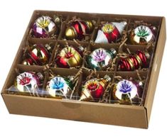 an open box filled with assorted christmas ornament's in different colors