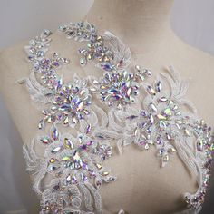 the back of a dress with sequins and jewels on it's neck