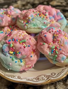 there are many cookies that have sprinkles all over them on the plate