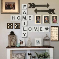 a white shelf topped with lots of pictures next to a wall filled with framed photos