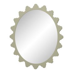 an oval mirror with scalloped edges on a white background