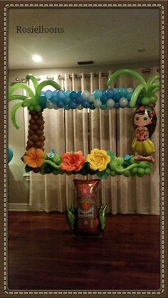 balloon decorations in the shape of flowers and palm trees