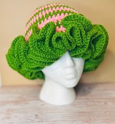 a crocheted hat on top of a white mannequin head