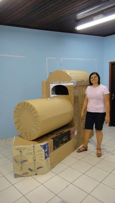 a woman standing next to some cardboard boxes