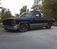 a black pickup truck parked in a parking lot