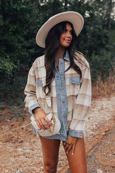 - This cozy layering piece has southern charm!
 - Fully lined warm material with a brown hued plaid print and  denim accents
 - A collared neckline A button closure front
 - Long, loose sleeves with button closure cuffs
 - Functional chest pockets as well as low side pockets
 - A relaxed silhouette that ends in a straight hemline Spring Flannel Collared Outerwear, Spring Flannel Button-up Outerwear, Spring Button-up Flannel Outerwear, Fall Khaki Outerwear With Corduroy Collar, Khaki Fall Outerwear With Corduroy Collar, Fall Collared Brown Shacket, Fall Brown Collared Shacket, Beige Collared Shacket For Fall, Neutral Button-up Shacket For Fall