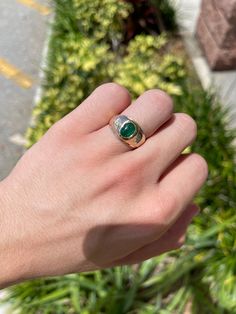 A beautiful three-stone, natural emerald cabochon, and diamond ring. The center stone cabochon has a full 1.36-carats, with a dark green color and very good luster. Accenting the cabochon are two petite brilliant round diamonds. This one-of-a-kind ring is in 10K yellow gold, with a satin finish going halfway down the band giving it the perfect touch. Setting Style: Three-Stone Setting Material: 10K Yellow Gold Gold Weight: 5.8 Grams Main Stone: Emerald Cabochon Shape: Oval Cut Weight: 1.36-Carat Fine Jewelry Emerald Ring With Oval Cabochon, Fine Jewelry Emerald Oval Cabochon Ring, Emerald Oval Cabochon Ring As A Gift, Emerald Oval Cabochon Ring In Fine Jewelry Style, Oval Cabochon Emerald Ring For May Birthstone, Fine Jewelry Emerald Oval Cabochon Ring For May Birthstone, Heirloom Oval Cabochon Emerald Ring, Green Emerald Ring With Oval Cabochon Bezel Setting, Classic Cabochon Emerald Ring