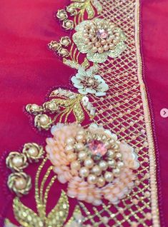 an embroidered red cloth with flowers and pearls on it