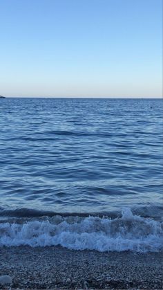 an ocean view with waves coming in to shore