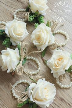 some white flowers and pearls on a table