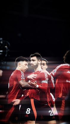 a group of men standing next to each other on a soccer field