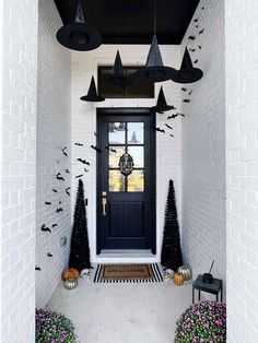 the front door is decorated for halloween with black decorations and bats hanging from the ceiling