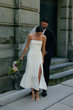 a bride and groom are standing on the steps