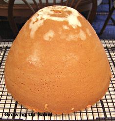 a round cake sitting on top of a cooling rack