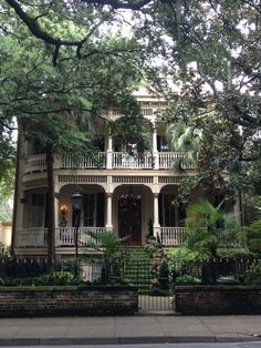 an old house with many balconies and trees