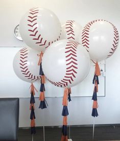 baseball balloons with tassels on them in an office