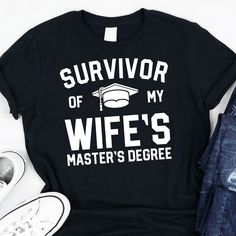 a black shirt that says survivor of my wife's master's degree